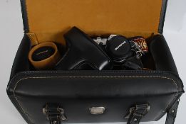 A good vintage Olympus OM10 slr camera with lens together with other cased lenses etc to include
