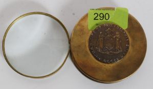 An antique style reproduction brass folding magnifying glass marked W.