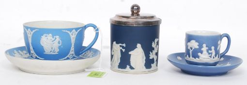 A Victorian Wedgwood light blue jasperware cup and saucer having cherub cameo scenes.