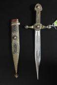 A decorative white metal filligree decorated ornamental dagger, with steel blade.
