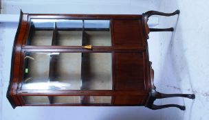 An Edwardian mahogany inlaid bow front tall display cabinet.