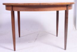 A 1970's G-Plan Chester range retro teak wood circular dining table raised on turned legs with