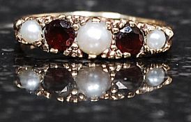 A 9ct gold, seed pearl and ruby stone ladies dress ring.