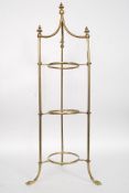A Victorian brass cake stand, decorated with finials to the top,