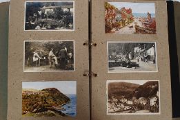 A vintage postcard album containing several postcards,