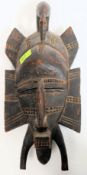 A traditional hand carved wooden Senufo mask. 17
