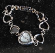 A 925 silver white metal ladies wrist watch with heart shaped dial, with mother of pearl face.
