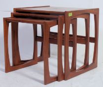 A G-Plan style Kelso nest of teak Danish tables. Each with shaped supports and graduating tops.