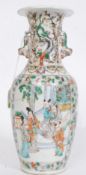 A 19th century Chinese famille rose vase with court scenes to the panels having fu dog and