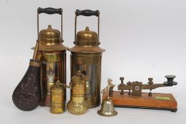 A mixed lot to include a pair of brass lamps, morse code tapper, powder flask,