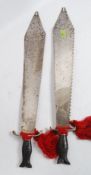 A pair of 20th century unusual decorative Indian / Asiatic saw back blade swords,