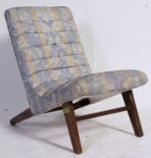 A vintage 1940's upholstered childs nursing chair raised on angled beech wood legs with ribbed