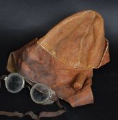 A vintage leather motorbike helmet ? along wih a pair of vintage goggles,