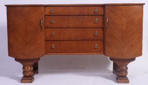 A 1960's faux wood sideboard dresser raised on shaped legs with drawers and cupboards.