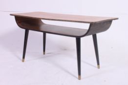 A 1970's teak and ebonised surfboard style retro coffee table.