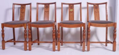 A set of four 1930's / 1940's matching oak dining chairs, having drop in leatherette seat pads.