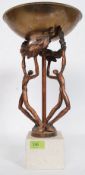 A  contemporary bronze and stone tazza having white metal bowl over raised figures on stone plinth