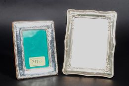 A silver (stamped 925 ) white metal photograph frame, along with another, unmarked.