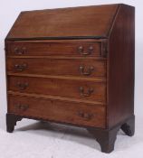 A 19th century mahogany Georgian country oak bureau desk raised on bracket feet with fully