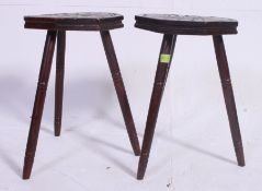 A pair of 20th century carved wood milking stools,