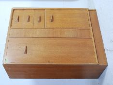 A blonde oak G plan E Gommes tall boy, having a full upright. Measures: 122 x 88 x 46.