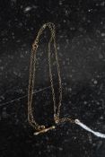 A ladies decorative 9ct gold necklace and bar pendant ( the chain marked 9ct ) Total weight 0.