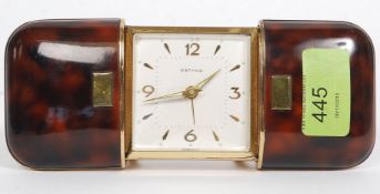 ESTYMA; a vintage simulated tortoiseshell cased self winding travelling clock,