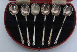 A cased set of 1930's Art Deco silver hallmarked coffee spoons each with chevron cast handles.