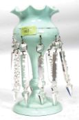 A 19th Century mint green glass table lustre with flanged border and gilded design and hung