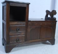 A Jacobean revival oak hall settle having carved griffin support with hinged top seat over box with