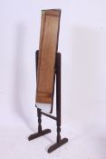 A Vintage 1940's oak cheval mirror raised on squared legs with rectangular mirror.