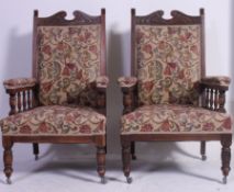 A pair of good Edwardian oak Art Nouveau ladies and gentlemans armchairs being raised on tapered