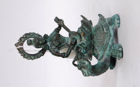A bronze Chinese figure of a deity atop a tortoise.
