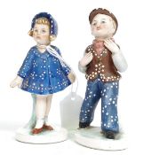 A pair of ceramic figurines of a boy and girl dressed as Pearly King and Queen stamped to base with
