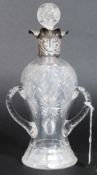 A silver hallmarked 3 handled cut glass decanter with stopper.
