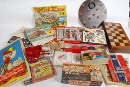 A box of Edwardian and later toys and games to include Victory jigsaw puzzles, YoYo's, chess set,