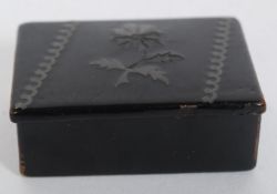 A 19th century papier mache gentlemans snuff box with thistle design to centre.