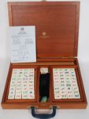 A 20th century contemporary cased bane and bamboo tiled Mah Jong set