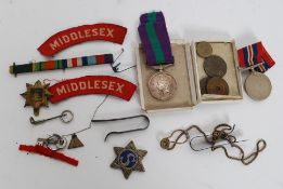 A Georve V service medal and ribbon awarded to 11848842 Gunner AE Hinkin, RA.