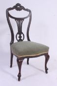 A Victorian ebonised mahogany Art Nouveau nursing chair.