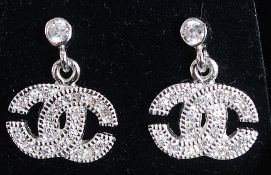 A pair of silver and cz shaped earrings, in the style of Chanel. Stamped 925 for silver.
