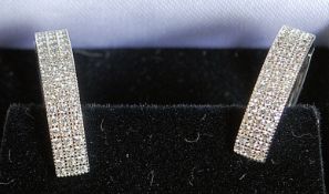 A pair of white metal / silver and cz ladies hoop earrings