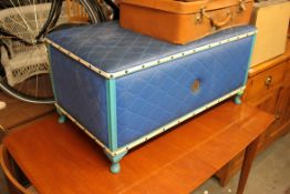A retro 1970's large blue vinyl upholstered blanket box ottoman having hinged top with crest to