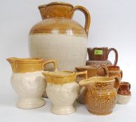 A collection of stoneware ceramics to include hunting scene jugs,