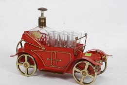 A vintage 1970's Decanter in the shape of a car with glasses to front.