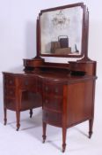 An Edwardian mahogany inlaid bow front dressing table chest of drawers.