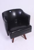 A 20th century black faux leather office swivel desk chair.