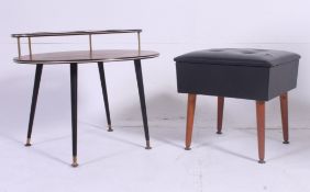 A vintage 1950's teak wood drink / cocktail table raised on ebonised supports with circular drop