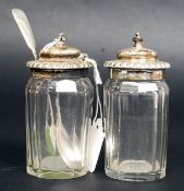 A pair of cut glass silver hallmarked topped cruets,