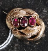 A 9ct gold and amethyst ladies brooch. The three central stones with leaf surrounds.